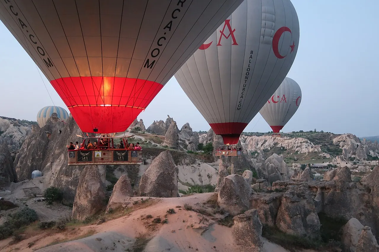 Balloons rising over the rock formations of Göreme