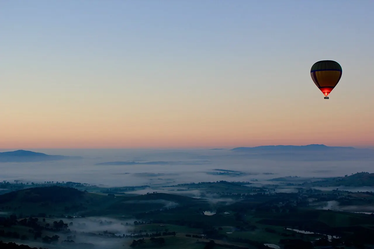 A hot air balloon over morning fog in the Yarra Valley near Melbourne