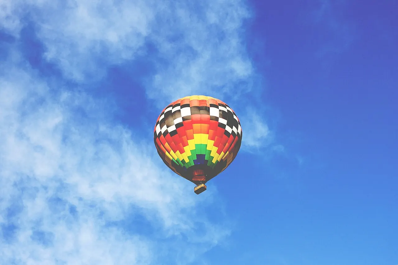 A hot air balloon in a blue sky over Phoenix
