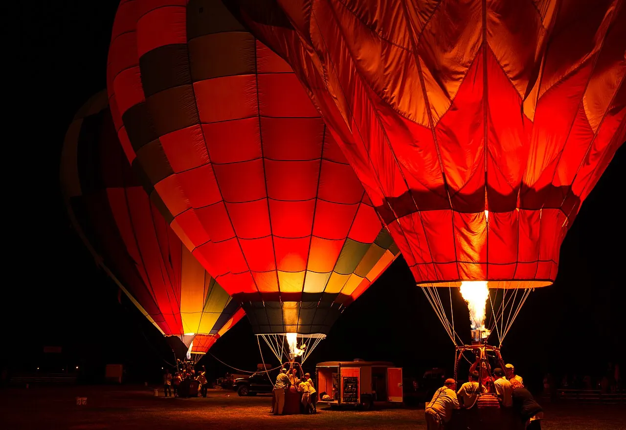 Hot air balloons glowing at dawn before launch in Sonoma County