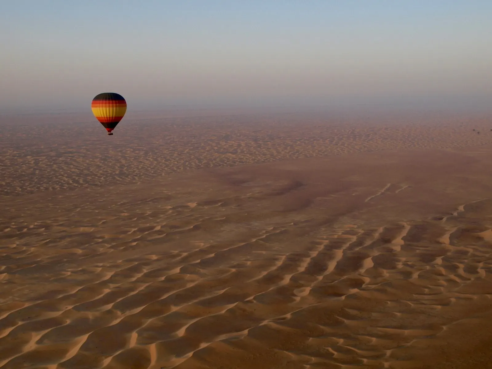A hot air balloon over the desert dunes outside Dubai